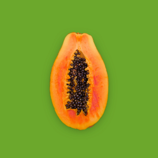 cut open papaya on green background